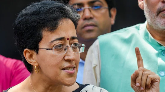 Why did Atishi drop her second name 'Marlena'?
