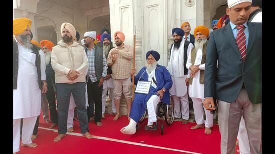 शिरोमणि अकाली दल के पूर्व अध्यक्ष सुखबीर सिंह बादल मंगलवार सुबह स्वर्ण मंदिर के प्रवेश द्वार पर एक घंटे तक सेवादार का नीला चोला पहने और बरशा (भाला) पकड़े रहे। (समीर सहगल/एचटी)